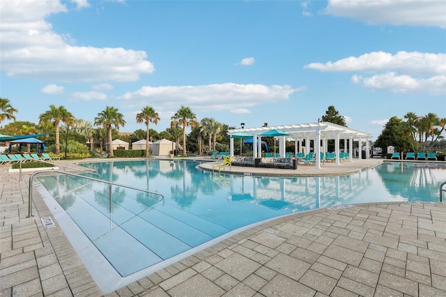 view of swimming pool featuring a pergola and a patio area