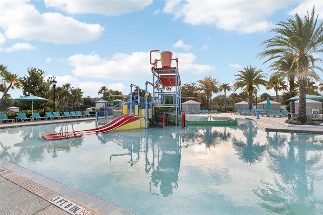 view of swimming pool with a playground