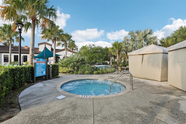 view of swimming pool with a community hot tub