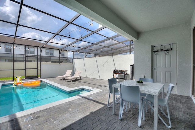 view of swimming pool featuring a lanai and a patio