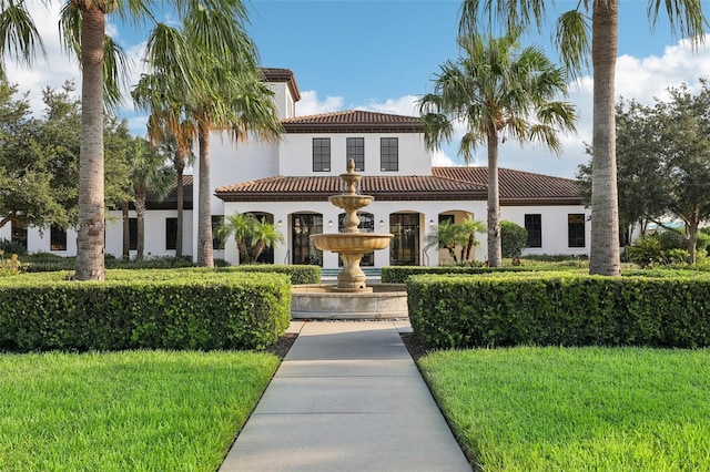 mediterranean / spanish-style house with a front yard