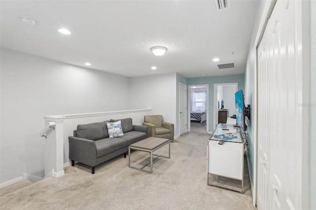 living room featuring light carpet and a textured ceiling