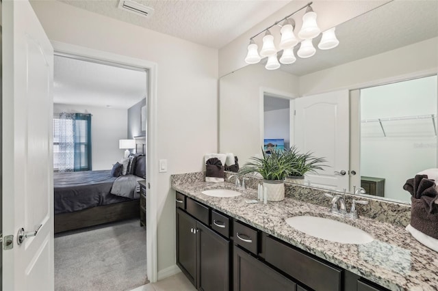 bathroom with vanity and a textured ceiling