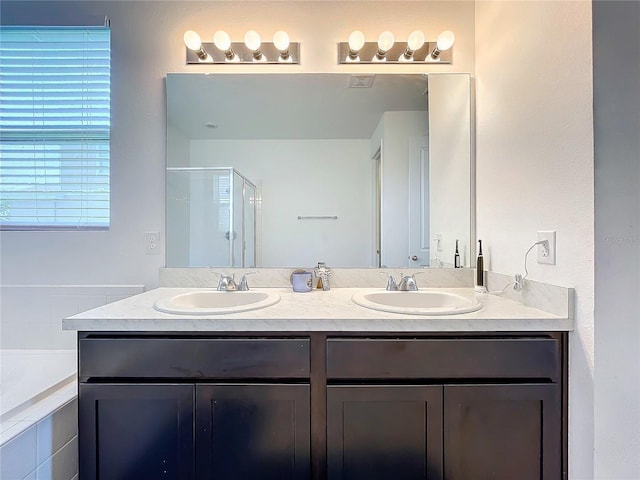 bathroom with vanity and separate shower and tub