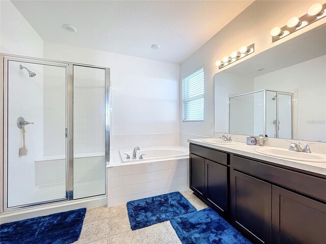 bathroom featuring tile patterned floors, vanity, plus walk in shower, and a textured ceiling