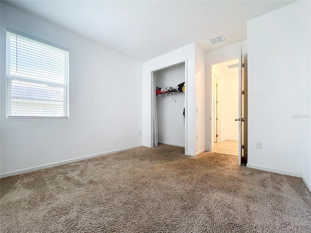 unfurnished bedroom with a closet and carpet floors