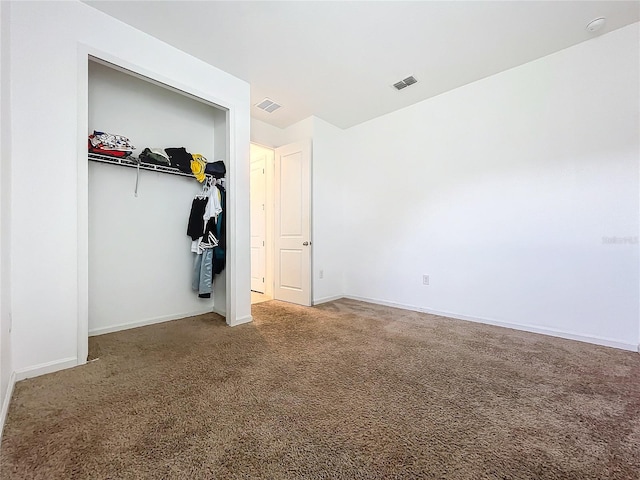 unfurnished bedroom featuring a closet and carpet