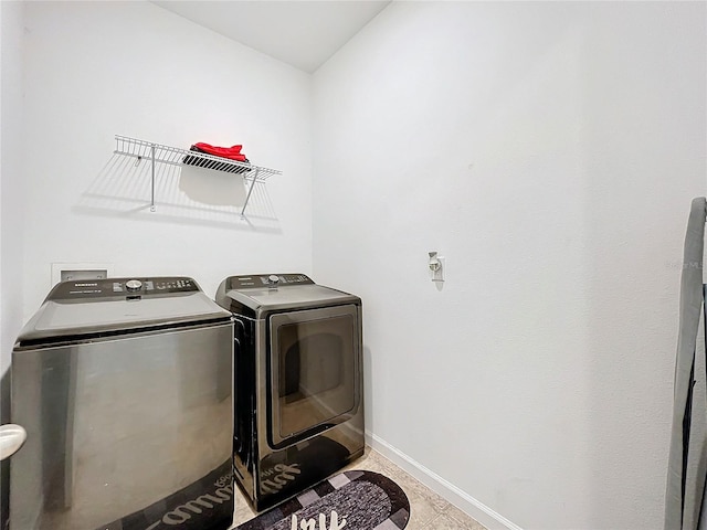 washroom featuring independent washer and dryer and light tile patterned floors