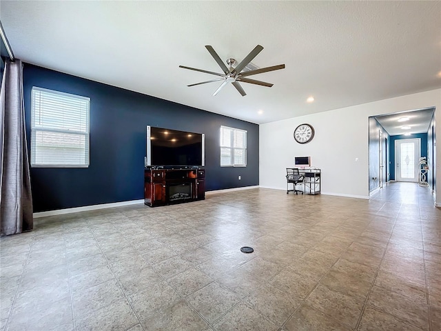 unfurnished living room featuring ceiling fan