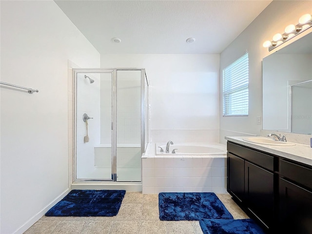 bathroom with vanity and independent shower and bath