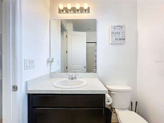 bathroom featuring vanity and toilet