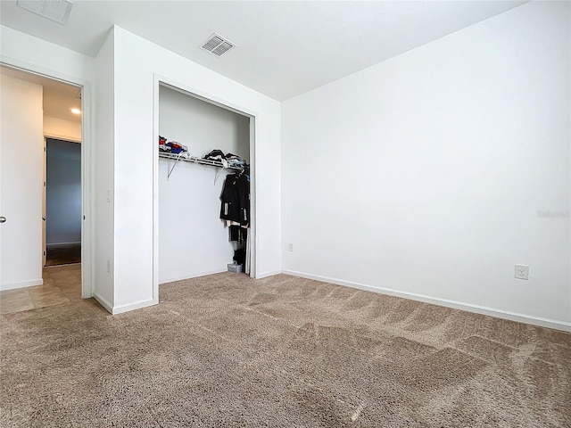 unfurnished bedroom with carpet floors and a closet