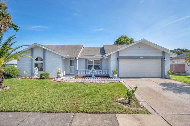 single story home featuring a garage and a front yard