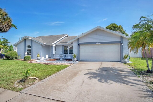 single story home featuring a garage and a front yard