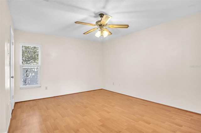 empty room featuring ceiling fan and light hardwood / wood-style flooring