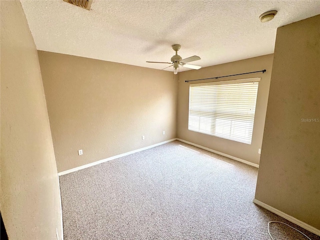 spare room with carpet floors, a textured ceiling, and ceiling fan