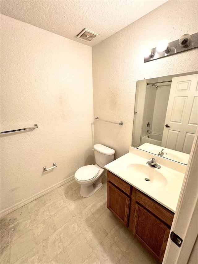 full bathroom featuring vanity, tile patterned floors,  shower combination, toilet, and a textured ceiling