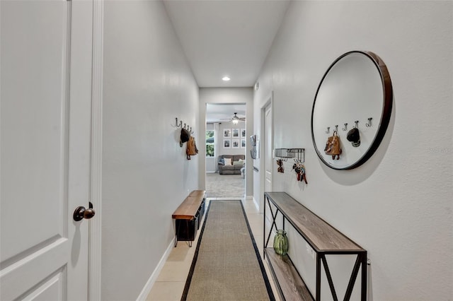 hall featuring light tile patterned floors