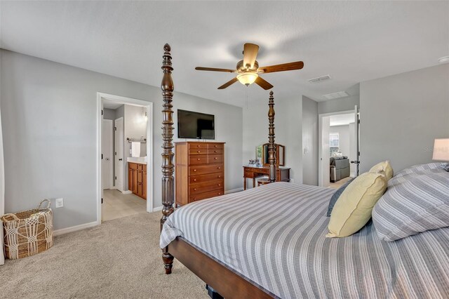 carpeted bedroom with ceiling fan and ensuite bathroom