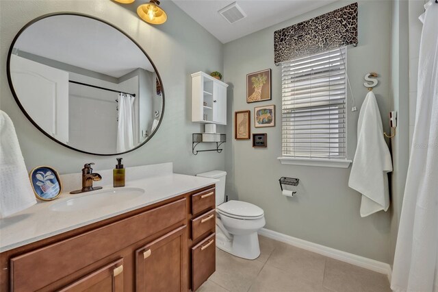 bathroom featuring tile patterned flooring, vanity, and toilet