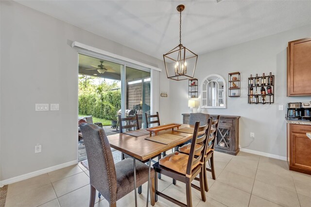 dining space featuring a notable chandelier and light tile patterned flooring