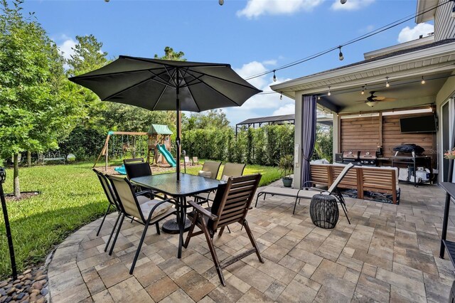 view of patio / terrace with ceiling fan, outdoor lounge area, and a playground