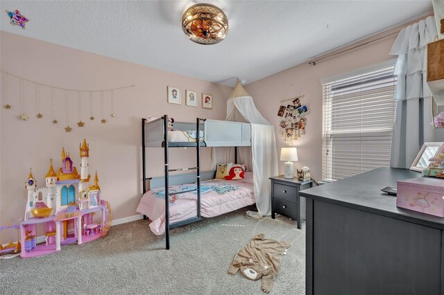 bedroom with carpet flooring and a textured ceiling