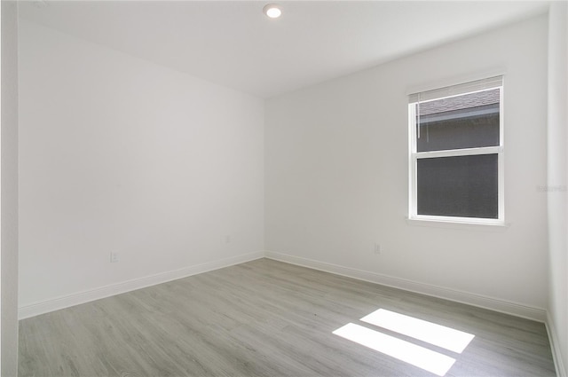 spare room featuring light wood-type flooring