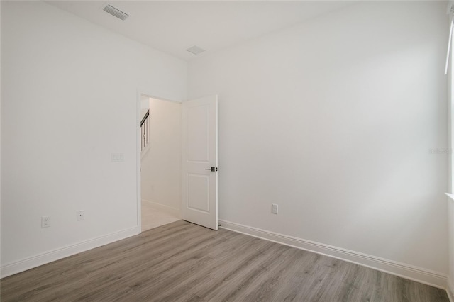 empty room with light hardwood / wood-style flooring