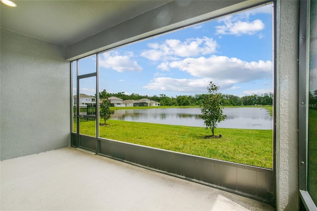 unfurnished sunroom with a water view