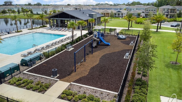 view of pool featuring a playground, a patio, a gazebo, a water view, and a lawn