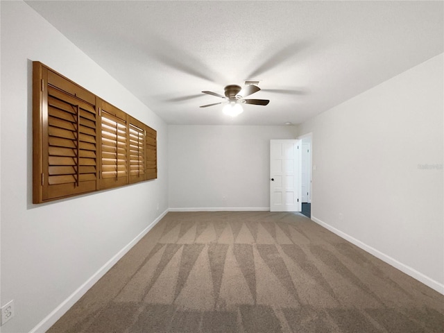 empty room with carpet flooring and ceiling fan