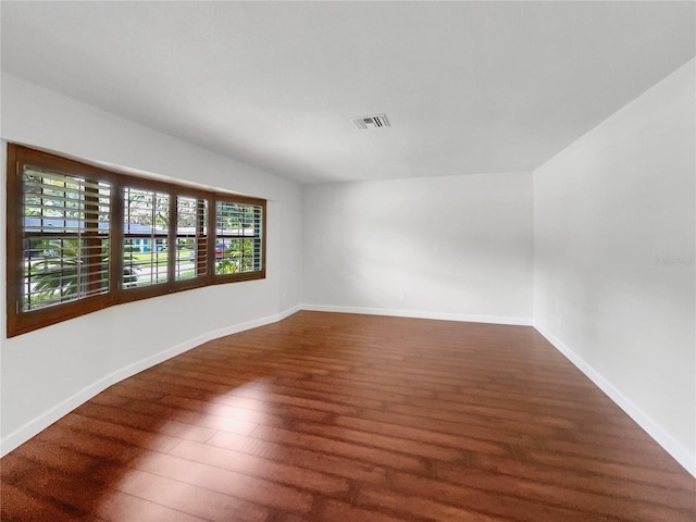 unfurnished room with dark hardwood / wood-style floors