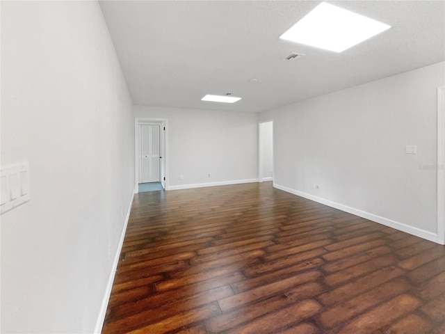 spare room with dark hardwood / wood-style floors