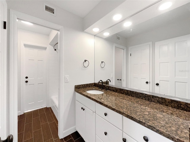 bathroom featuring tile patterned floors, shower / tub combination, and vanity