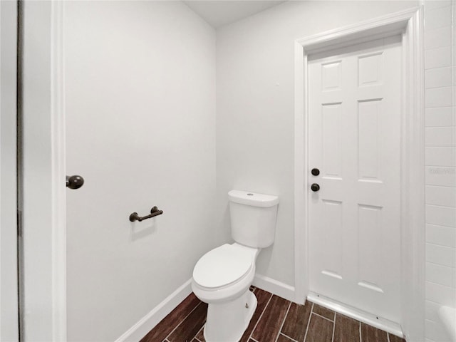 bathroom featuring hardwood / wood-style floors and toilet