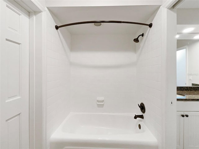 bathroom with vanity and tiled shower / bath combo