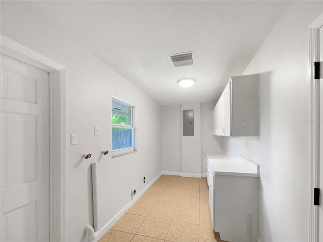 washroom featuring light tile patterned flooring, electric dryer hookup, cabinets, electric panel, and washer hookup