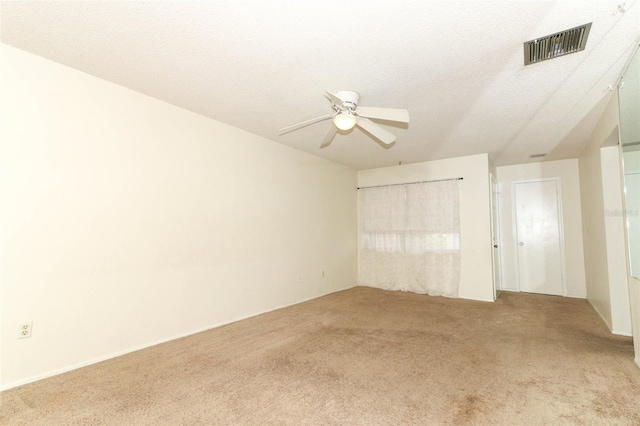 unfurnished bedroom featuring a ceiling fan, visible vents, a textured ceiling, and carpet flooring