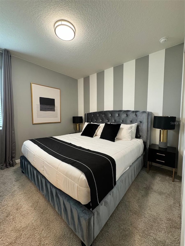 bedroom featuring carpet flooring and a textured ceiling