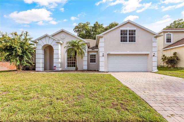 view of front of home featuring a garage and a front lawn