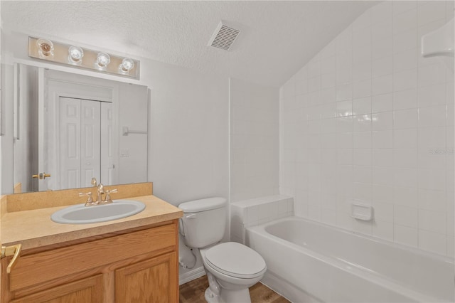 full bathroom with vanity, wood-type flooring, a textured ceiling, toilet, and lofted ceiling