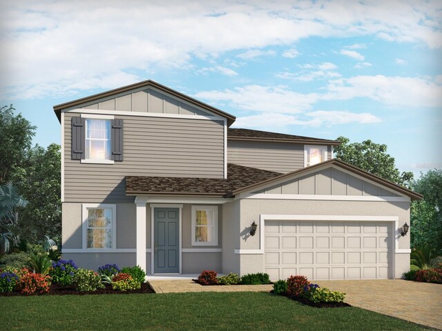 view of front of home featuring a garage and a front yard