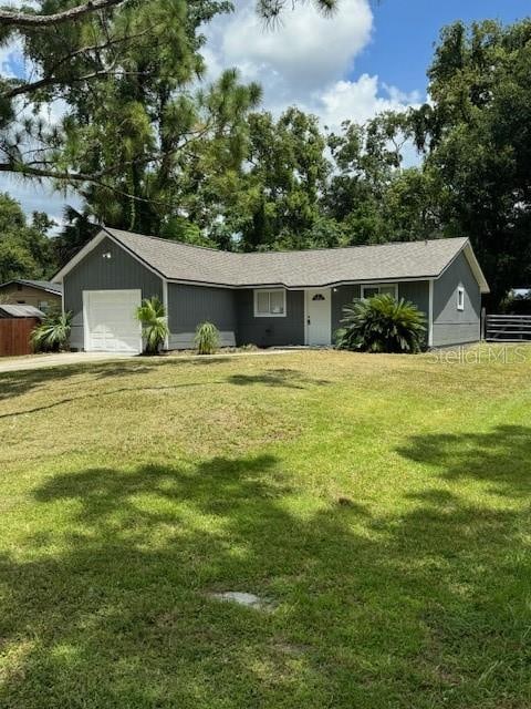 ranch-style house with a front lawn and a garage