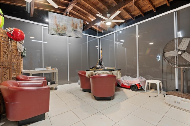 interior space with ceiling fan, wood ceiling, and tile patterned flooring