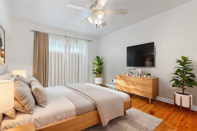 bedroom featuring ceiling fan and light hardwood / wood-style flooring