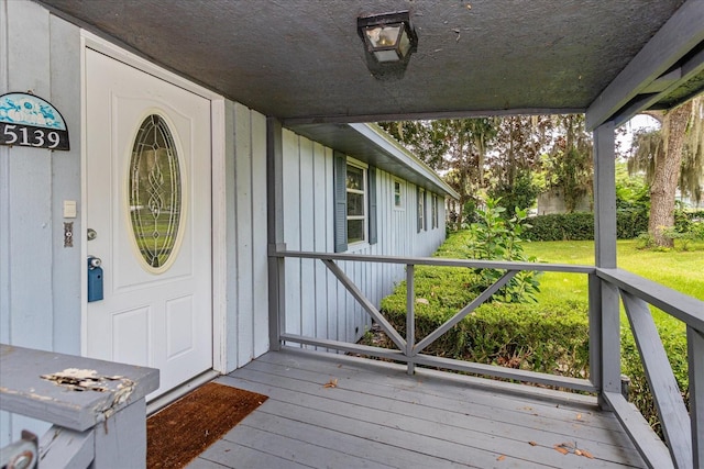 doorway to property with a lawn