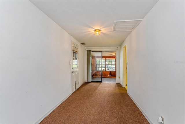 corridor featuring light colored carpet