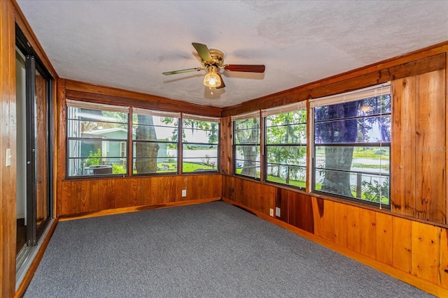 unfurnished sunroom featuring ceiling fan