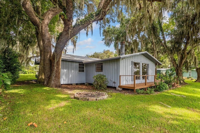 back of house with a yard and a wooden deck